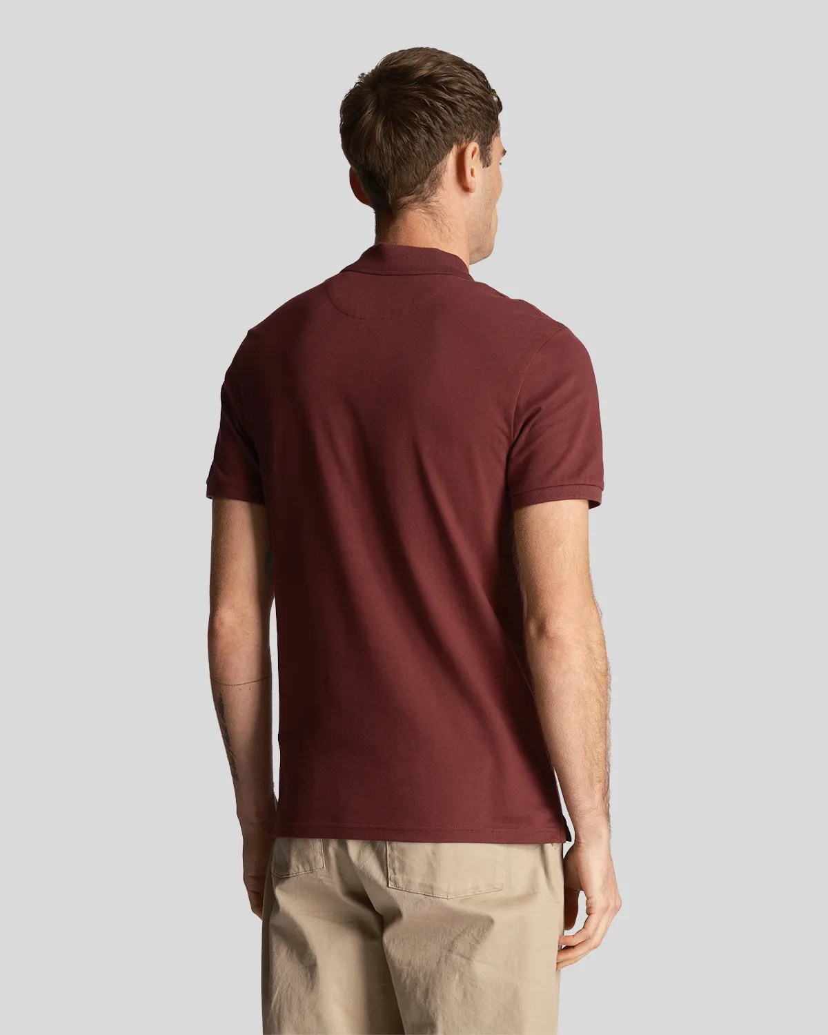 Polo bordeaux mezza manica in piqué di cotone stretch con logo aquila gialla ricamato